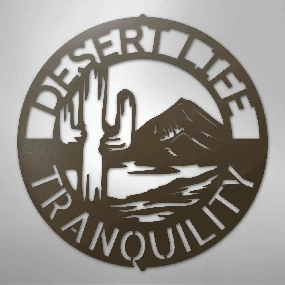 Round brown metal wall art with "DESERT LIFE TRANQUILITY" text, saguaro cactus, and mountain landscape.