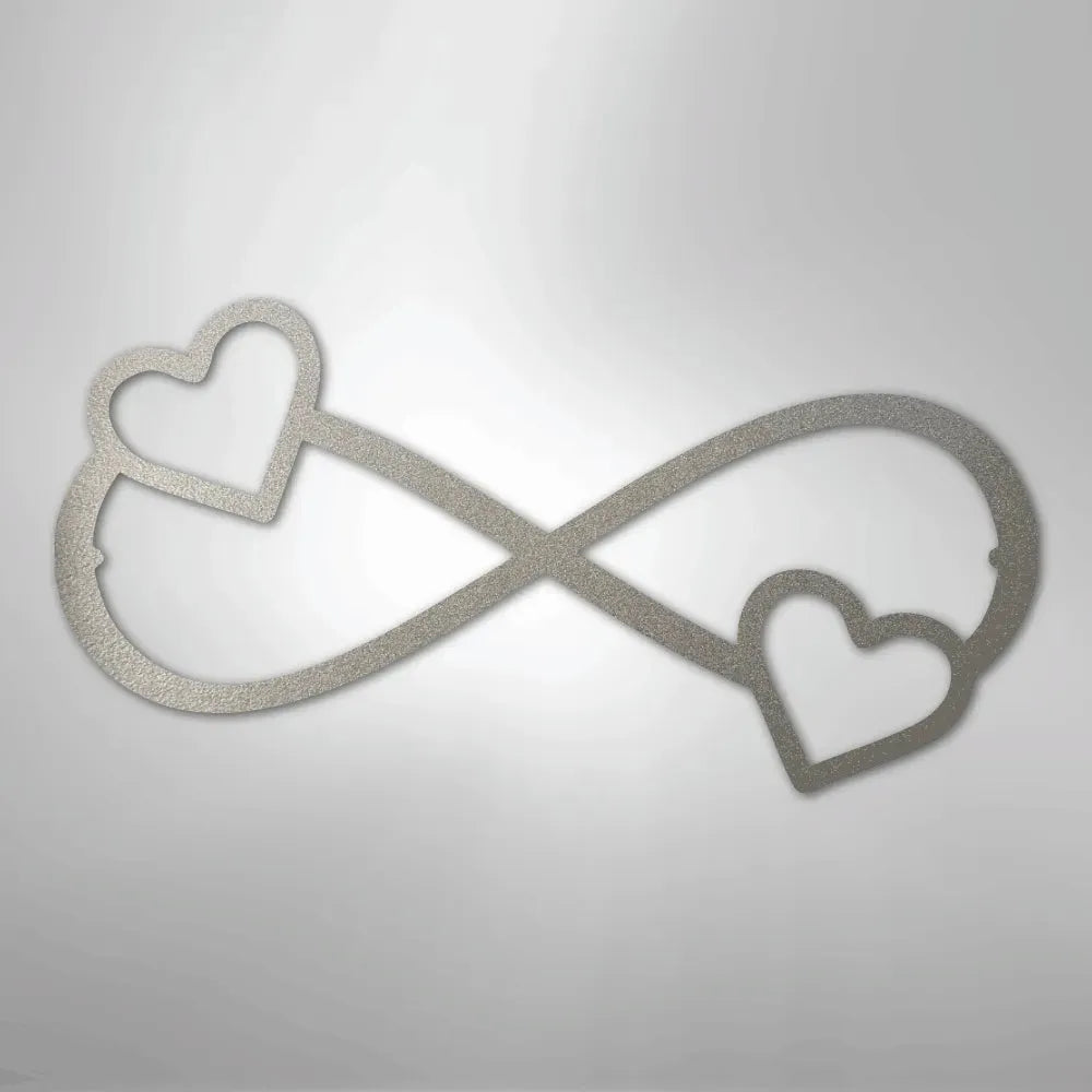 Silver metal infinity symbol wall art with two hearts, one on each loop.