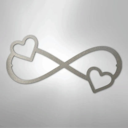 Silver metal infinity symbol wall art with two hearts, one on each loop.
