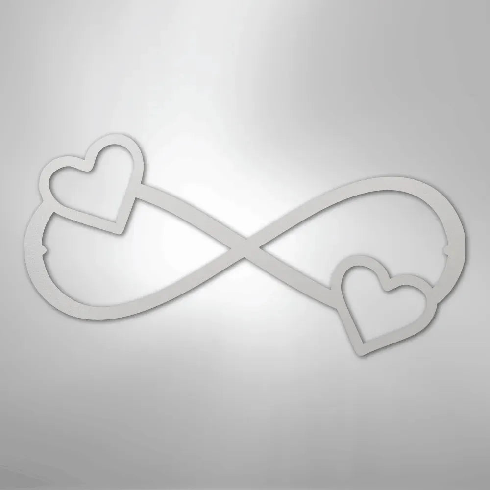 White metal infinity symbol wall art with two hearts, one on each end.