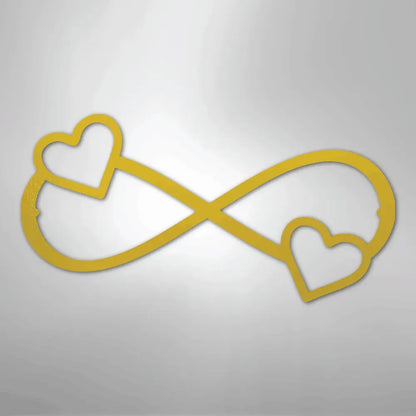 Gold metal infinity symbol wall art with two hearts, one on each side.