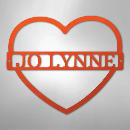 Red heart-shaped metal wall art with "JOLYNNE" cut out in the center.