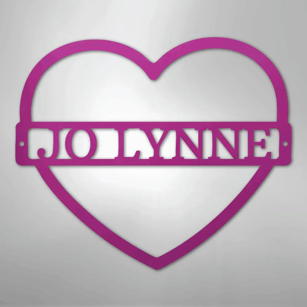 Pink heart-shaped metal wall art with the name "JOLYNNE" cut out in the center.