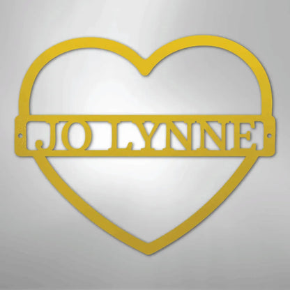 Gold metal heart wall art with "JOLLYNNE" monogram.