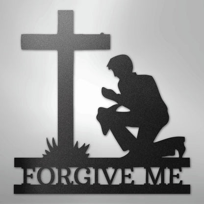 Black metal wall art depicting a kneeling man praying before a cross, with "FORGIVE ME" cut out below.