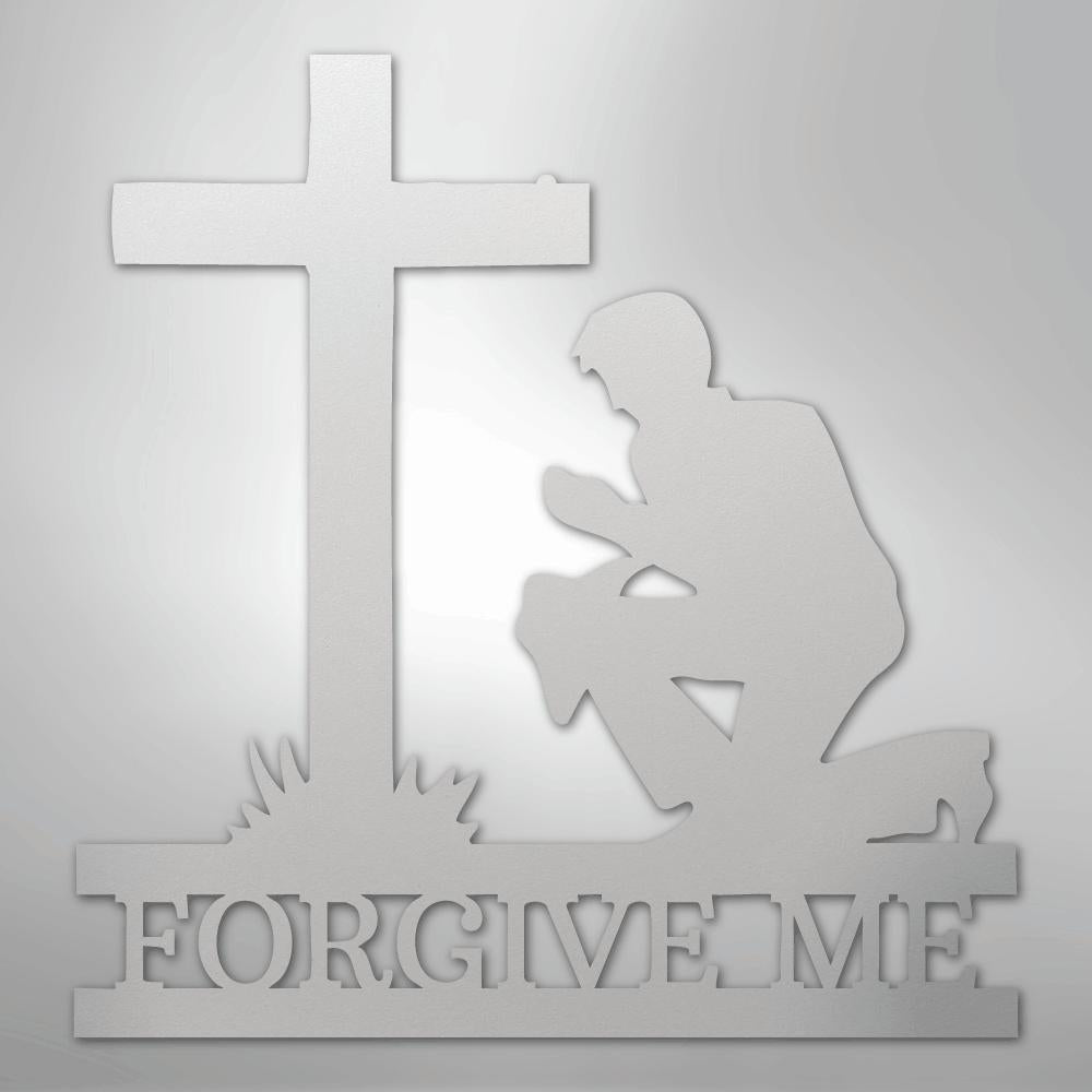 White metal wall art featuring a kneeling man praying before a cross, with "FORGIVE ME" cut out below.