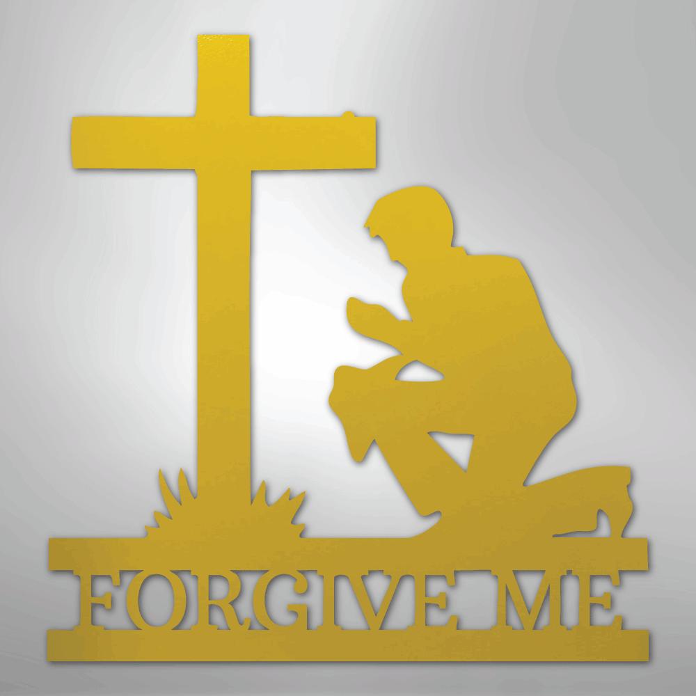 Gold metal wall art of a man kneeling before a cross, with "FORGIVE ME" cut out below.