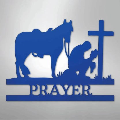 Blue metal wall art: kneeling cowboy, horse, cross, and "PRAYER" text.