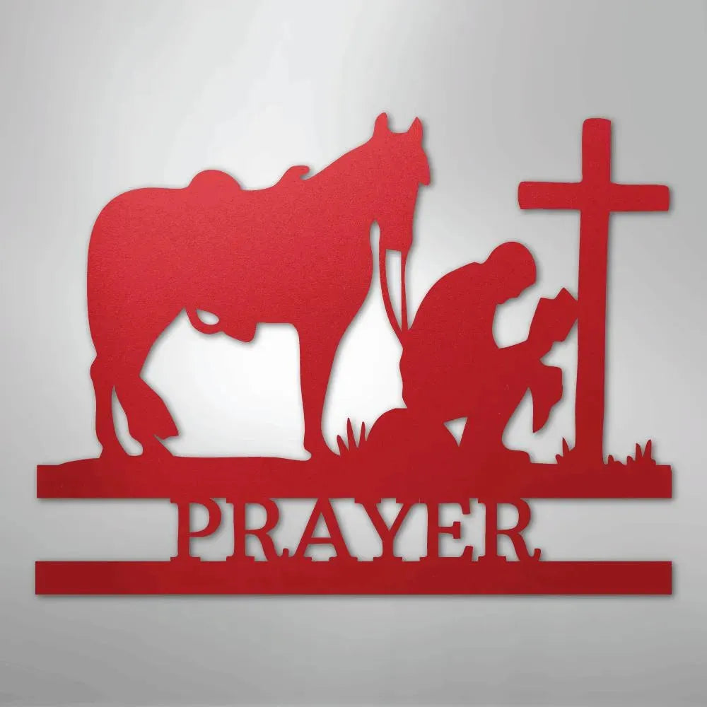 Red metal wall art: cowboy kneeling by a cross with a horse, "PRAYER" below.