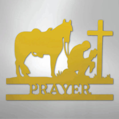 Gold metal wall art: cowboy kneeling by a cross with a horse, "PRAYER" below.