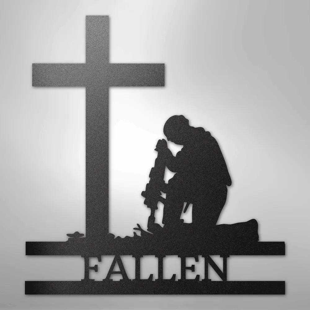 Black metal wall art of a kneeling soldier silhouette before a cross with "FALLEN" below.