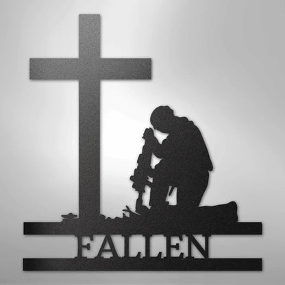 Black metal wall art of a kneeling soldier silhouette before a cross with "FALLEN" below.