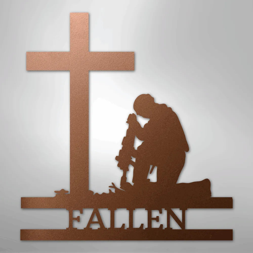 Copper metal wall art depicting a kneeling soldier with a rifle before a cross, with "FALLEN" below.