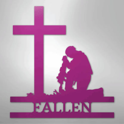 Pink metal wall art of a kneeling soldier silhouette before a cross, with "FALLEN" below.
