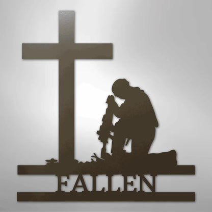 Dark brown metal wall art of a kneeling soldier silhouette with a rifle, cross, and "FALLEN" text.