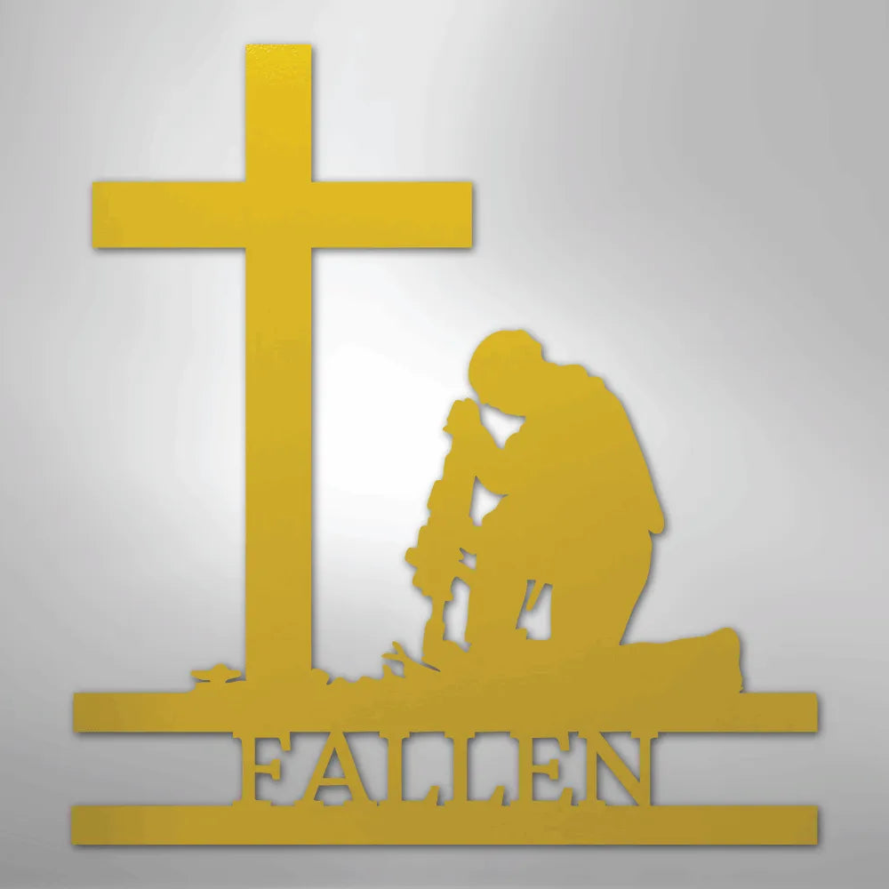 Gold metal wall art of a kneeling soldier silhouette with a cross and "FALLEN" text.