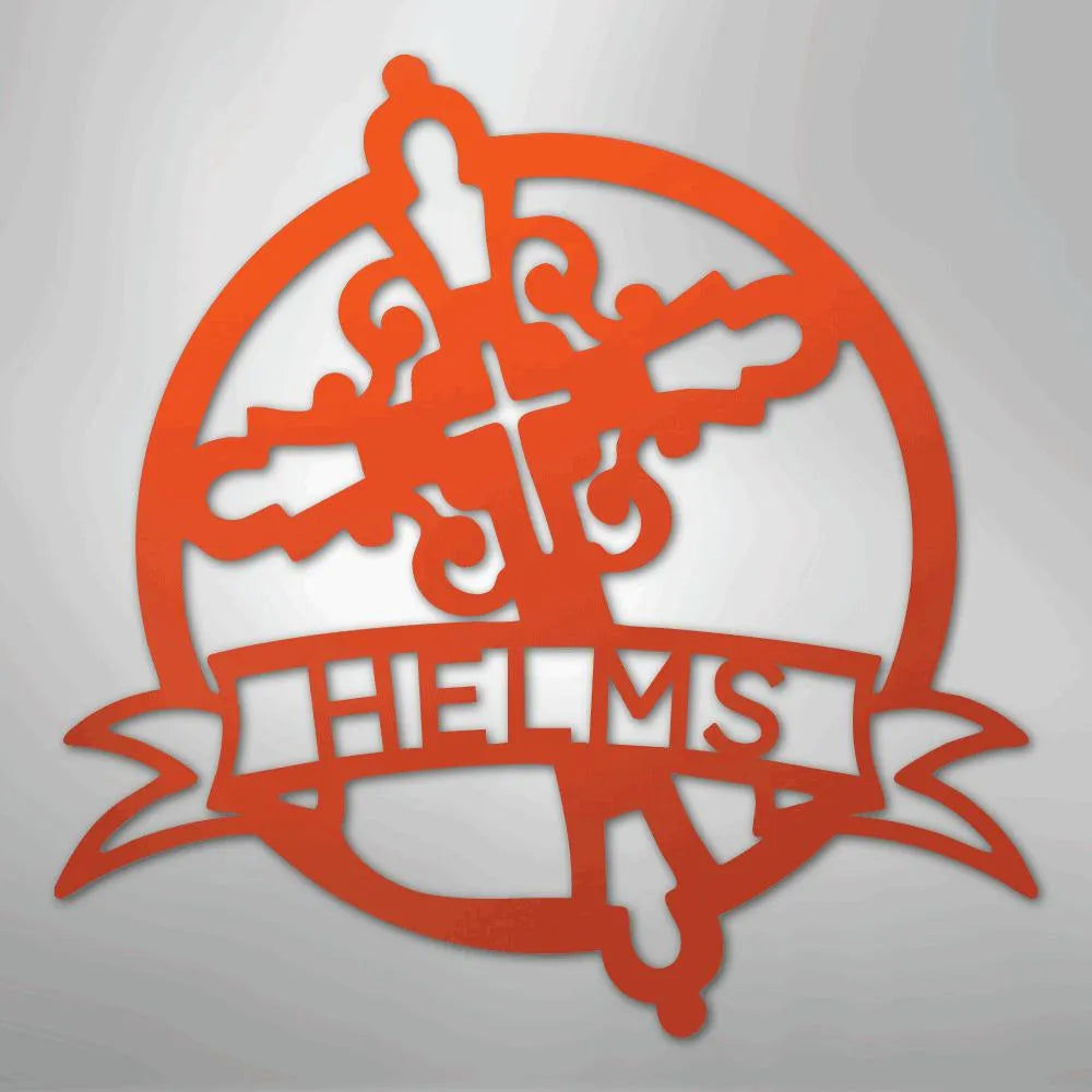 Orange metal wall art with a decorative cross, circle, and "HELMS" on a banner.