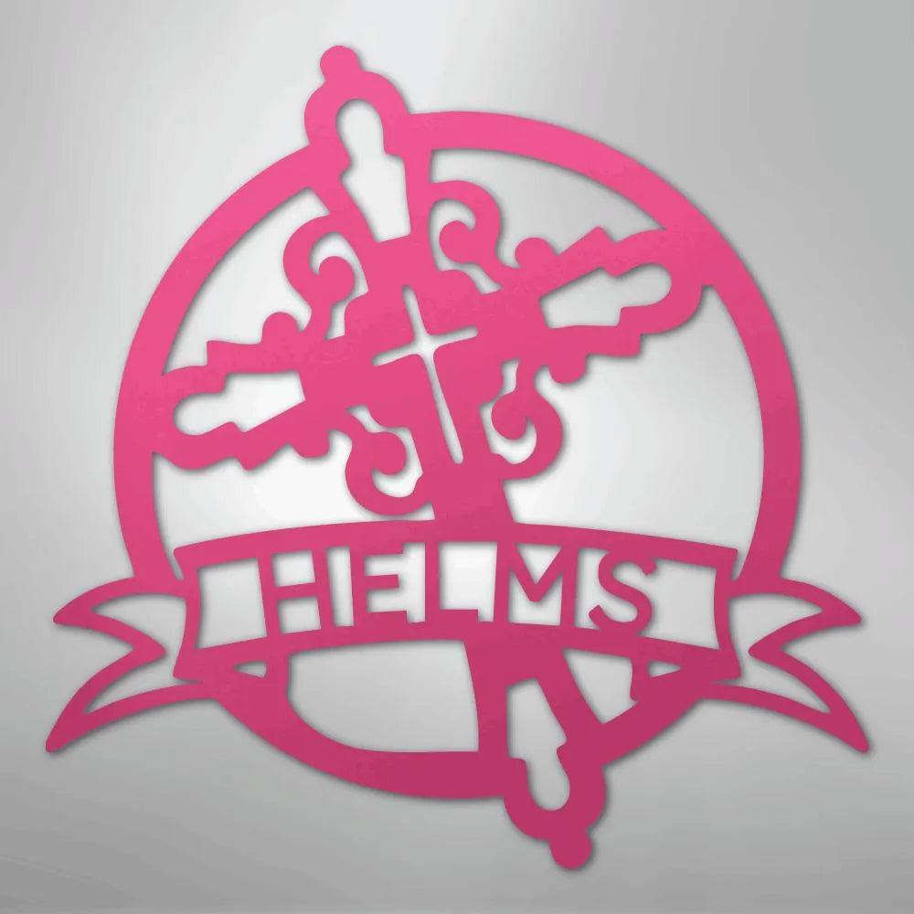 Pink metal Catholic monogram wall art with a decorative cross, circle, and "HELMS" banner.