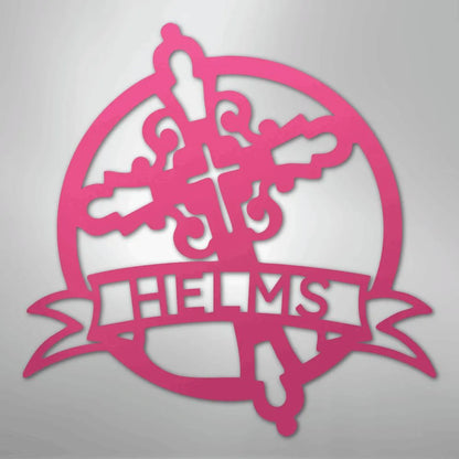 Pink metal Catholic monogram wall art with a decorative cross, circle, and "HELMS" banner.