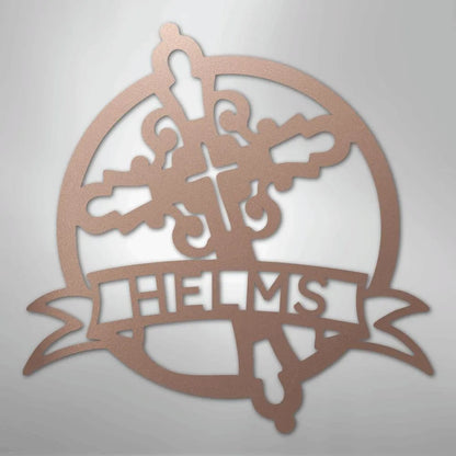Rose gold metal wall art with a circular cross design and "HELMS" on a banner.