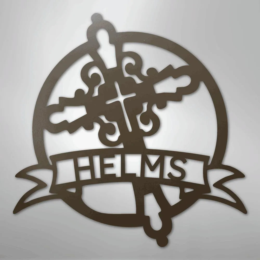 Brown metal Catholic monogram wall art with a cross, ornate flourishes, and "HELMS" on a banner.