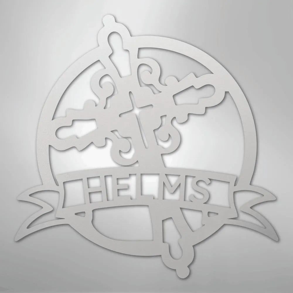 White metal Catholic monogram wall art with a cross, ornate design, and "HELMS" on a banner.