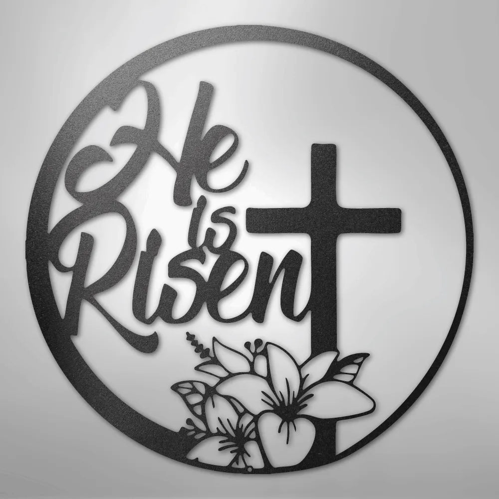 Black metal "He is Risen" wall art with a cross and lilies in a circular design.