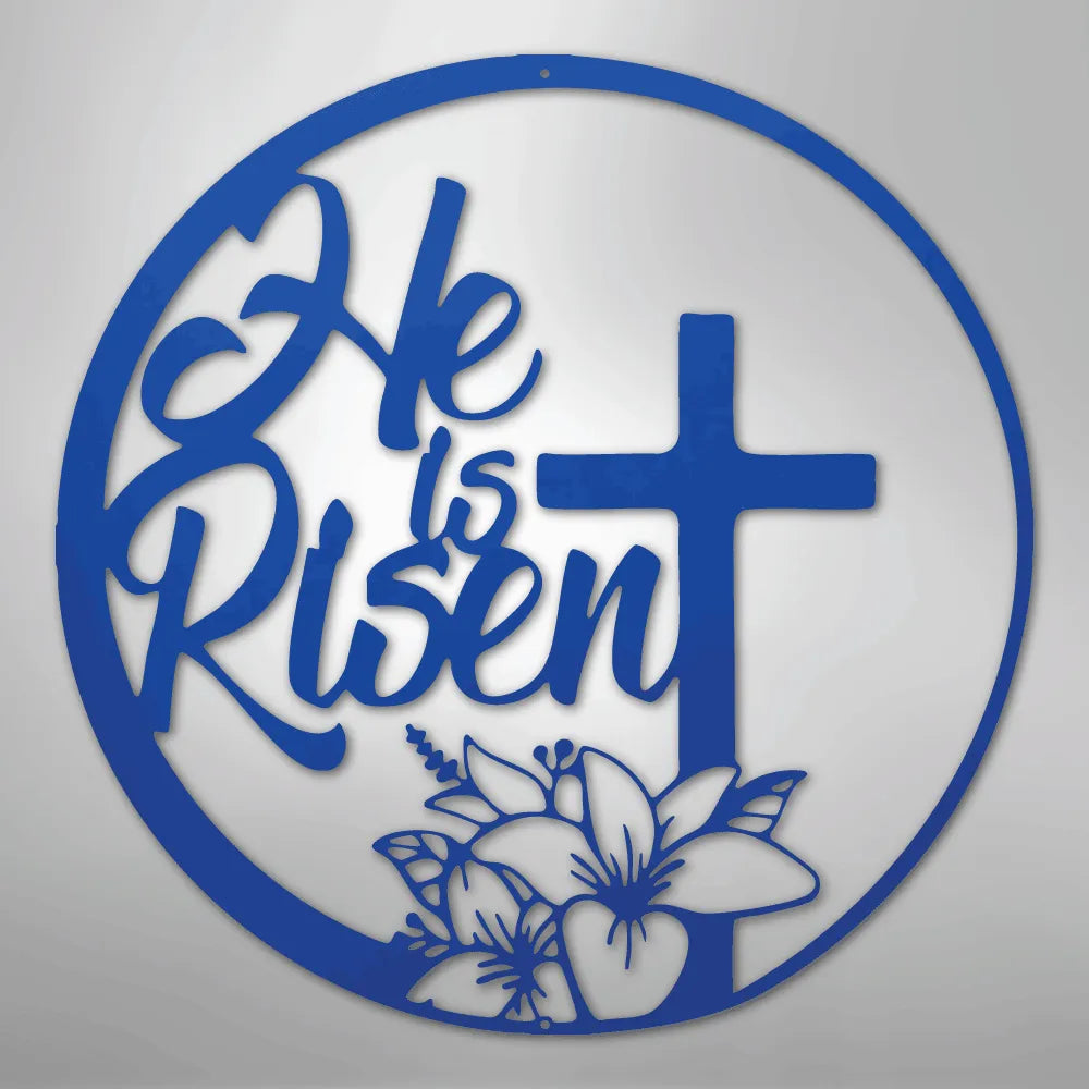 Blue metal wall art with "He is Risen" in script, a cross, and lilies within a circular frame.