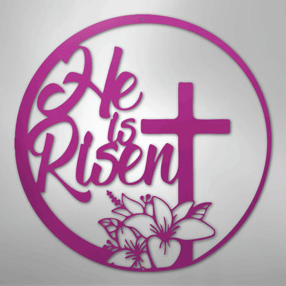 Pink "He is Risen" metal wall art with a cross and lilies in a circular design.