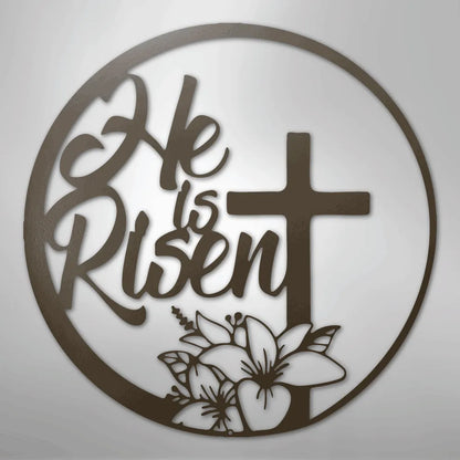 Brown metal "He is Risen" wall art with a cross and lilies inside a circular frame.