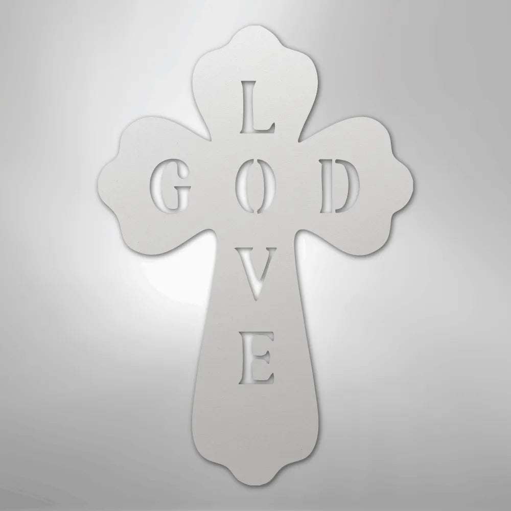 White metal wall art cross with "GOD LOVE" cut out, featuring decorative scalloped edges.