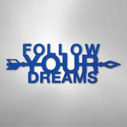 Blue metal "Follow Your Dreams" wall art with decorative arrows on a light background.