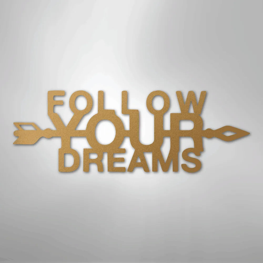 Gold metal wall art spelling "Follow Your Dreams" with an arrow design, inspiring decor.