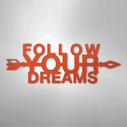 Orange metal "Follow Your Dreams" wall art with an arrow design, inspiring decor.