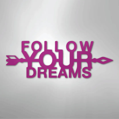 Magenta "Follow Your Dreams" metal wall art with an arrow design.