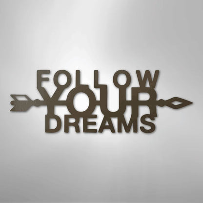 Brown metal wall art with "FOLLOW YOUR DREAMS" text and an arrow design.