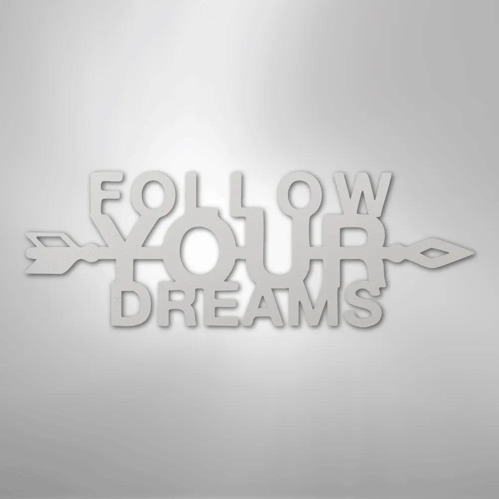 White "Follow Your Dreams" metal wall art with arrow accents, crafted from American steel.
