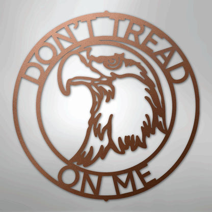 Copper metal wall art: "Don't Tread on Me" text encircles an eagle head in a round design.