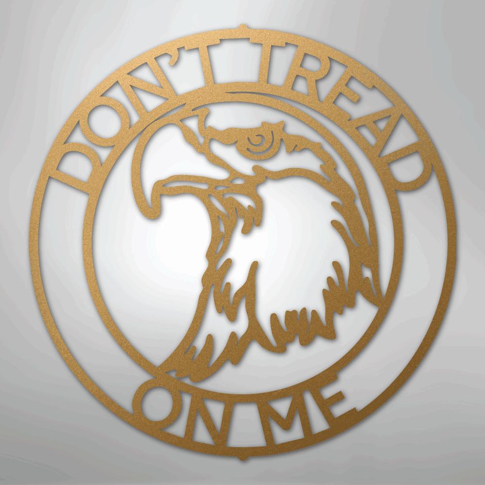 Gold metal wall art with an eagle head inside a circle, text "DON'T TREAD ON ME" around the edge.