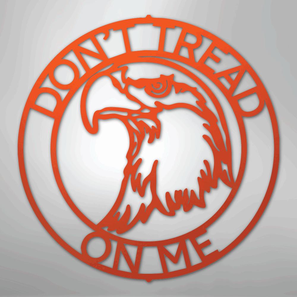 Orange metal wall art with an eagle head inside a circle, "DON'T TREAD ON ME" text.