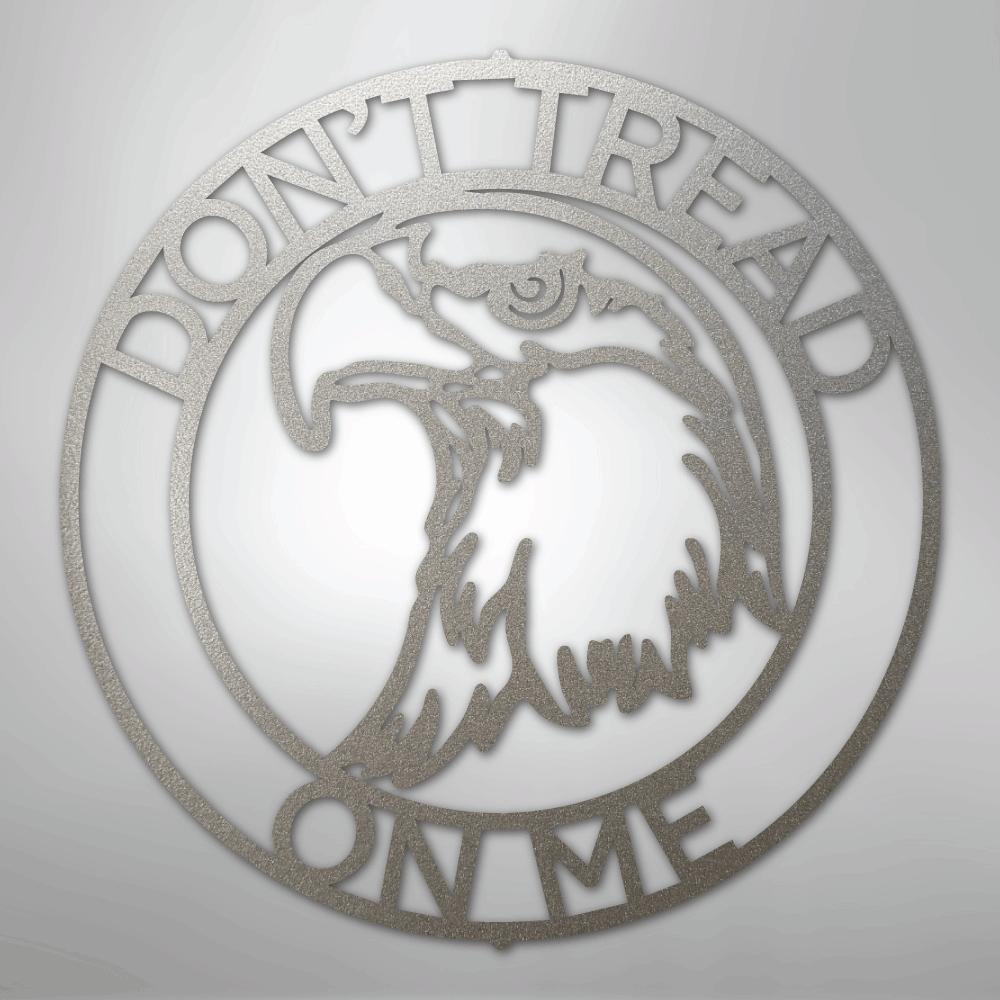 Silver metal wall art with an eagle head inside a ring, featuring "DON'T TREAD ON ME" text.