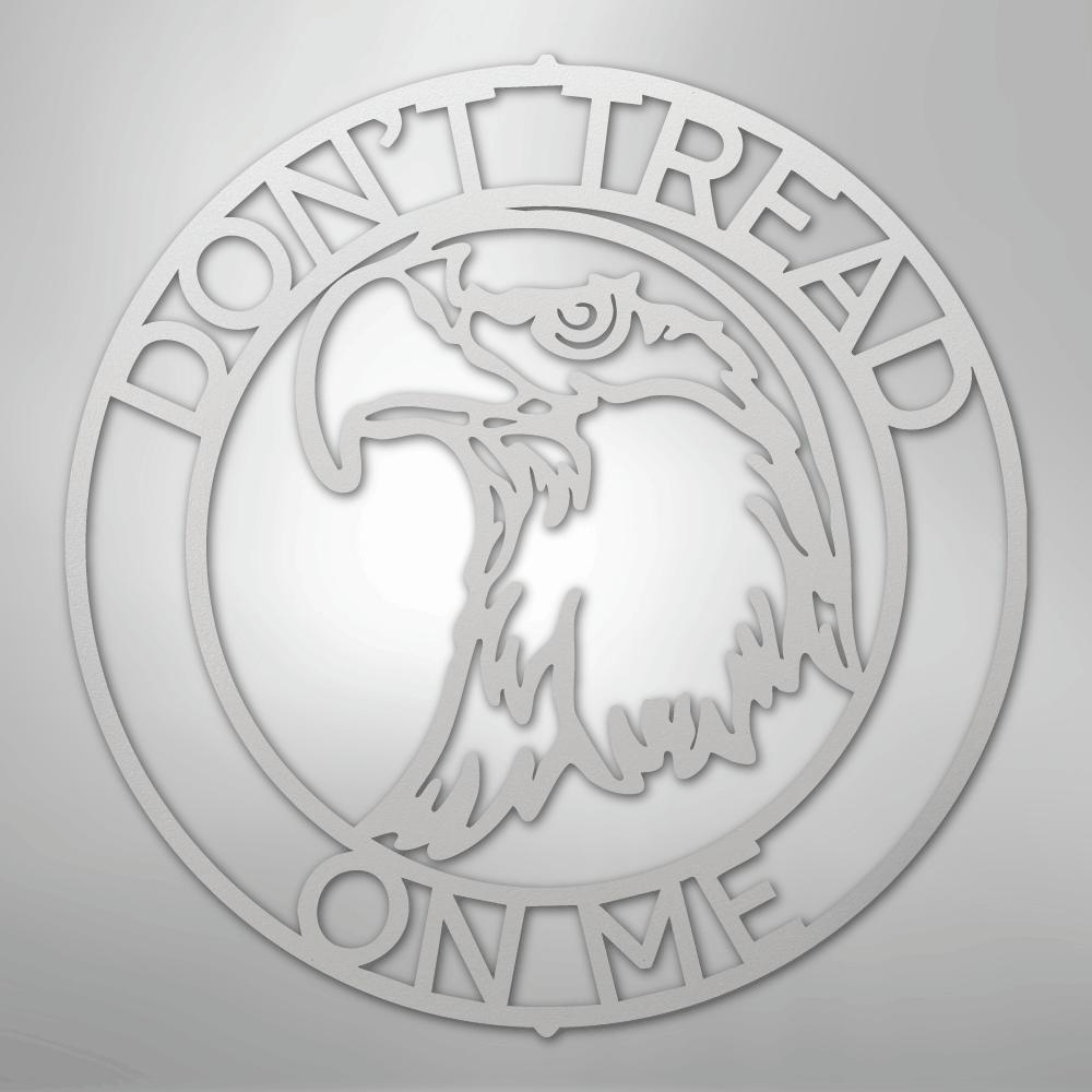 Silver metal wall art featuring an eagle head in a circular "Don't Tread On Me" monogram.