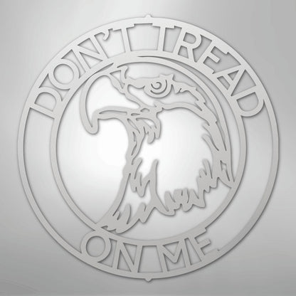 Silver metal wall art featuring an eagle head in a circular "Don't Tread On Me" monogram.