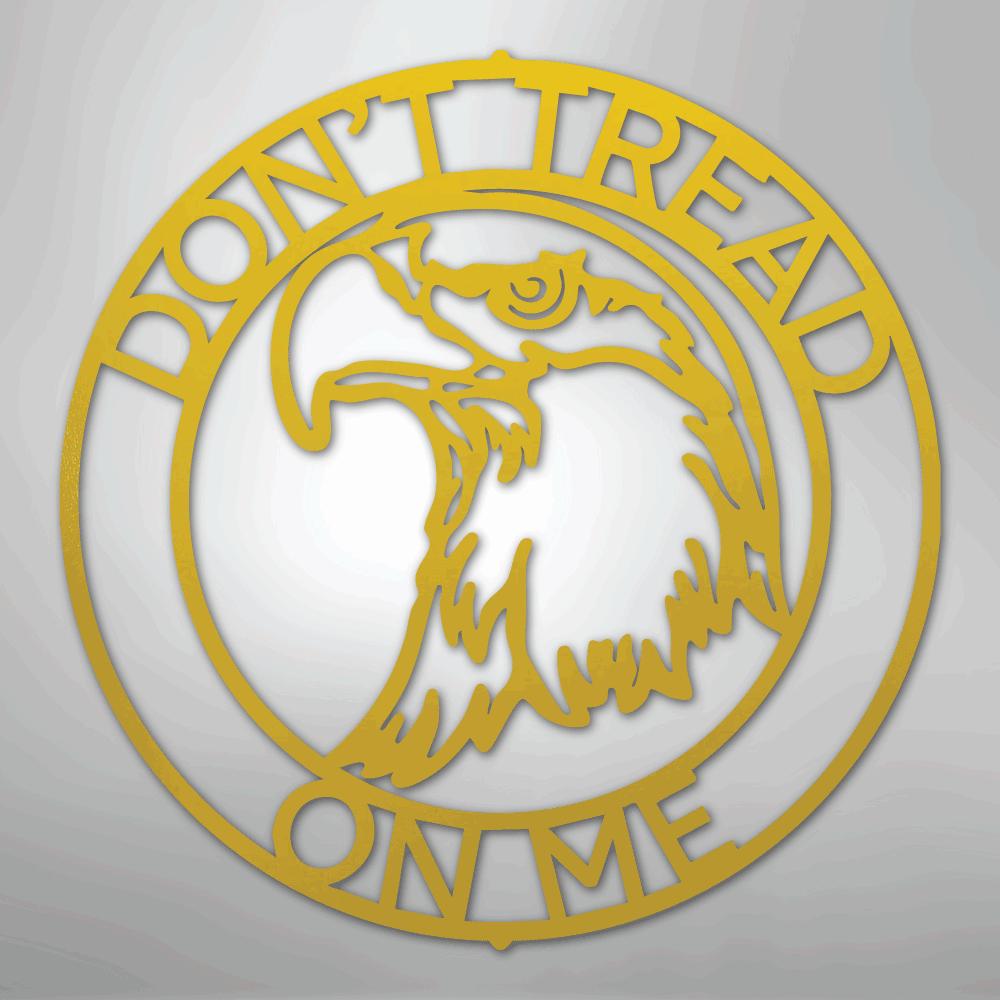 Gold metal wall art featuring an eagle head in a ring with "DON'T TREAD ON ME" text.