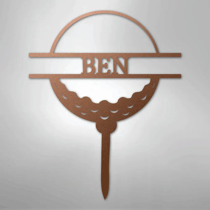 Copper metal golf ball monogram wall art with "BEN" cut out, on a tee.