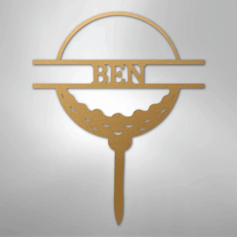 Gold metal wall art featuring a golf ball monogram with the name "BEN" in the center.