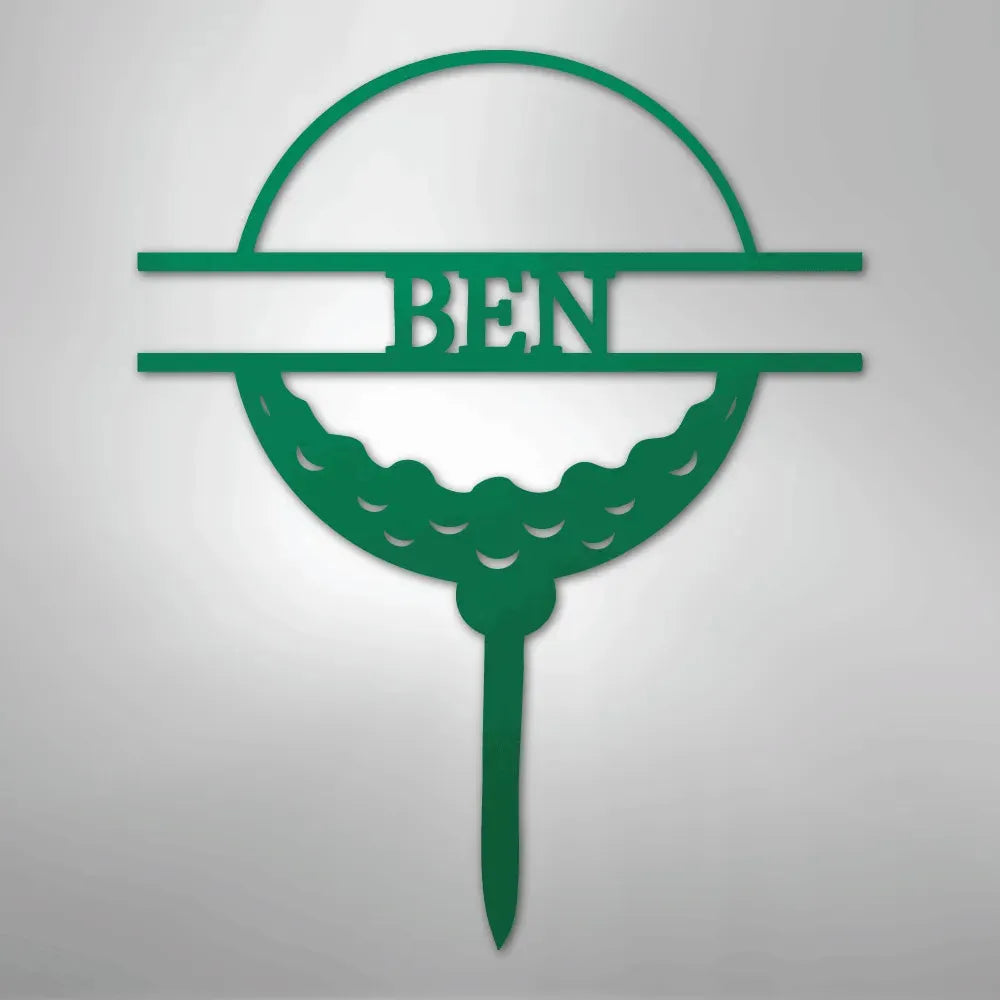 Green metal golf ball monogram wall art with "BEN" cut out, on a tee.