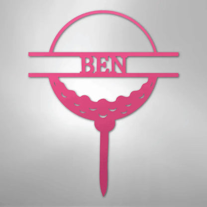 Pink metal golf ball monogram wall art with "BEN" cut out, on a tee.