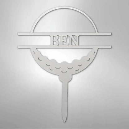 White metal golf ball monogram wall art with "BEN" cut out, featuring a tee base.