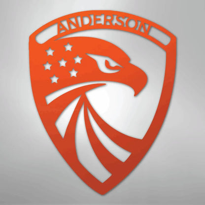Red metal shield with an eagle head, stars, and "ANDERSON" custom text.